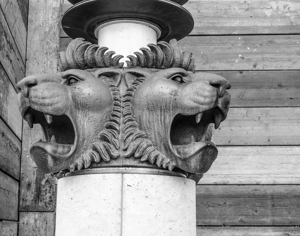 Two brass lions bearing their teeth