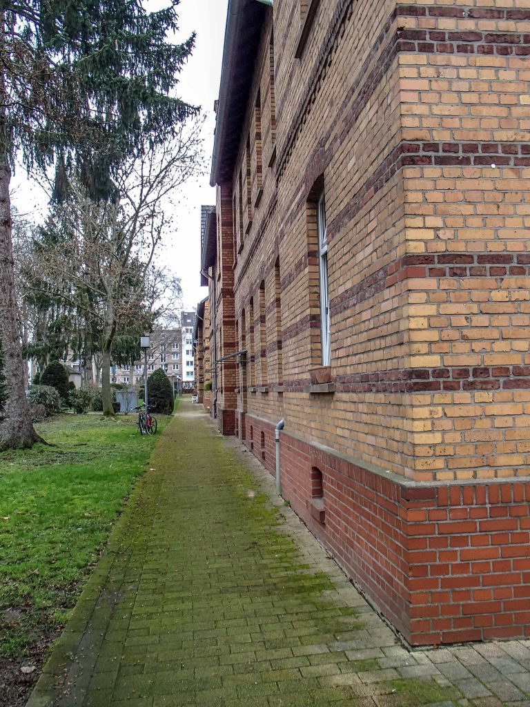 View of a brick building and a green lawn